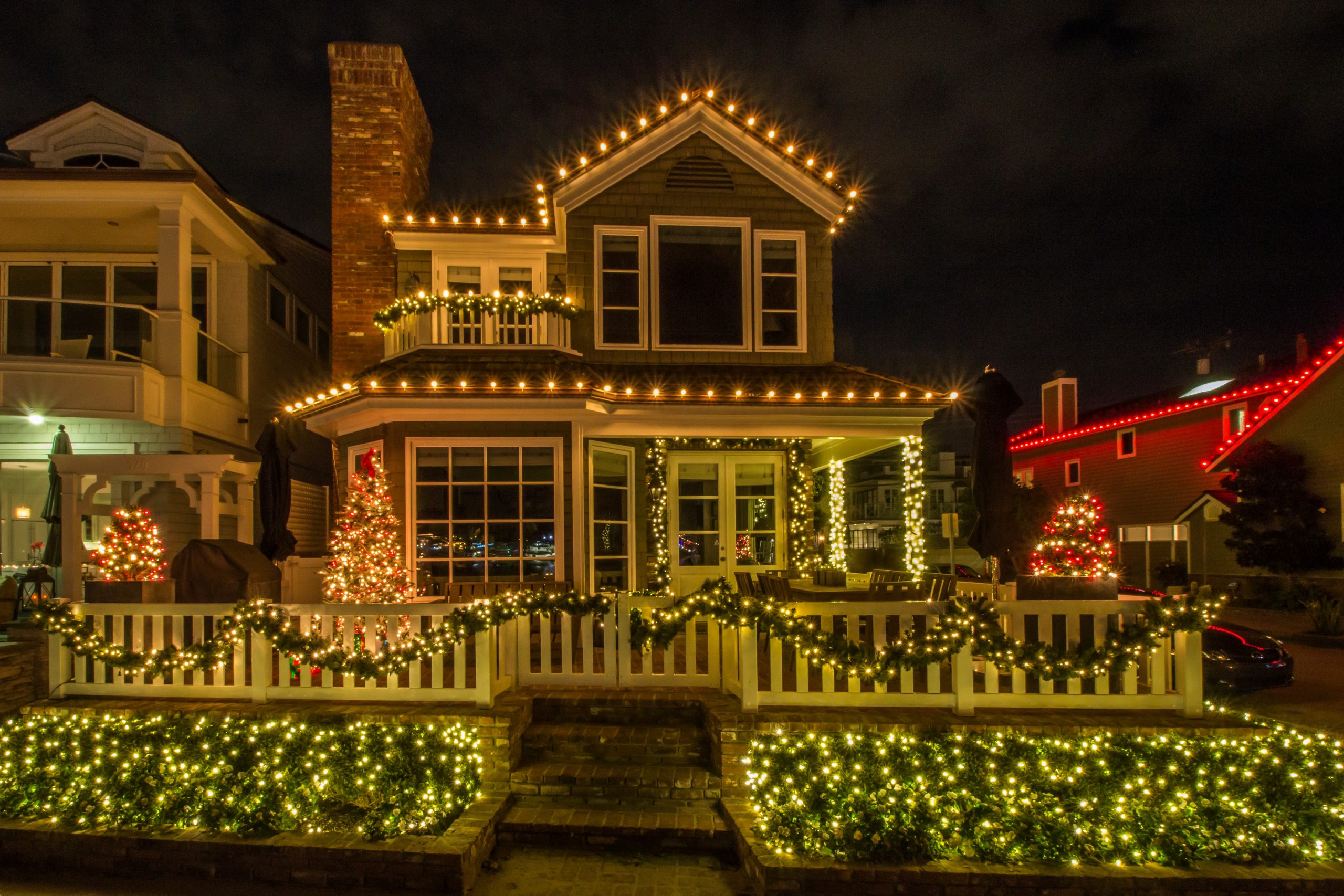 Strings of white holiday lights adorn this house and create a simple and inviting impression, making potential buyers think, 'I want to live there!'